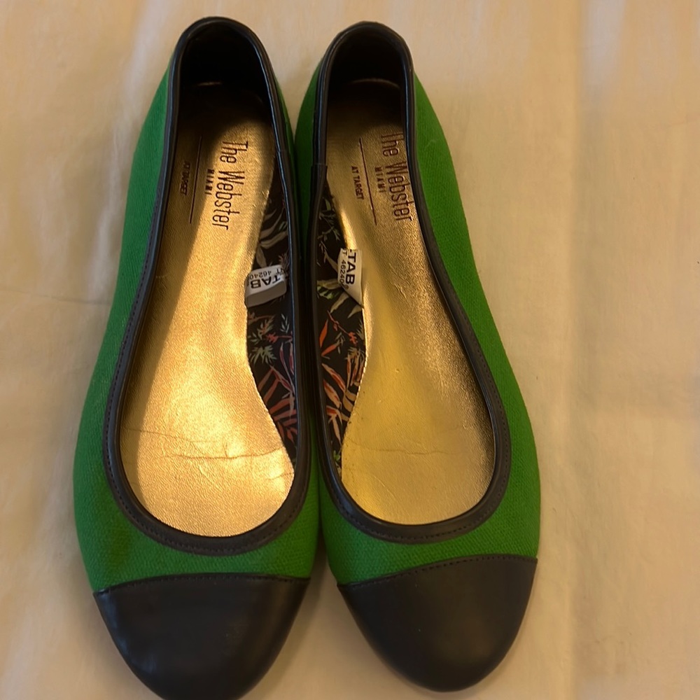 Green fabric ballet flats with navy leather capped toes and trim